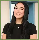 Smiling female dental team member in black shirt at Las Cruces dental practice.